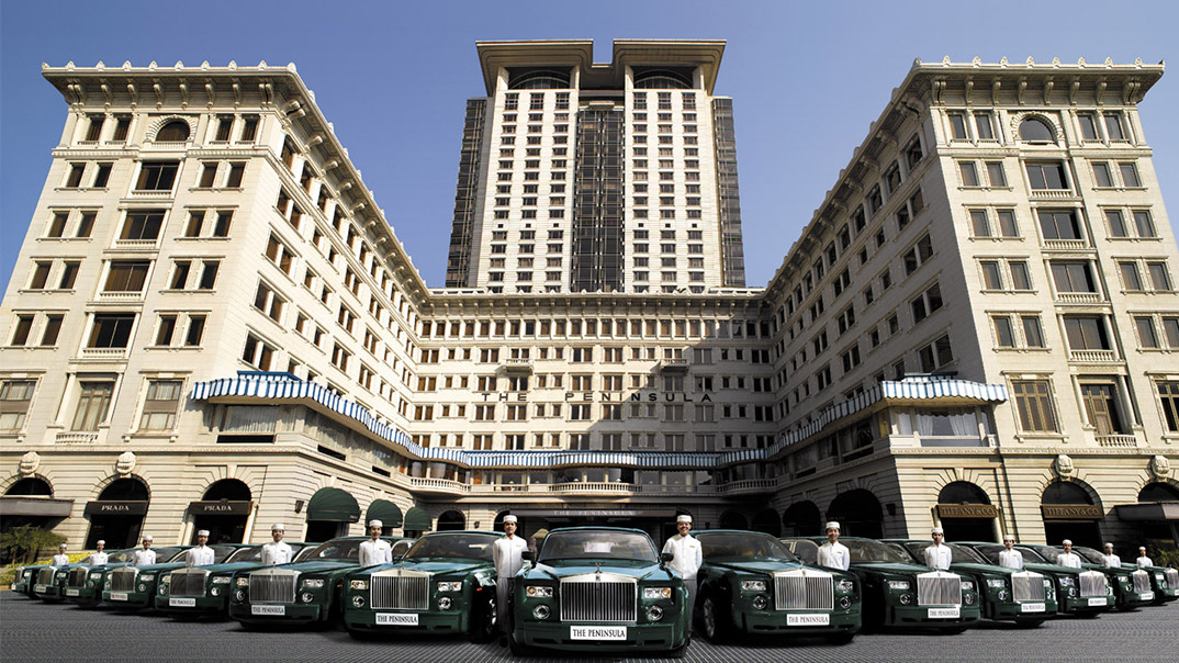 The Peninsula Hong Kong's iconic colonial-era façade in Tsim Sha Tsui — the 1928 grande dame hotel facing the Victoria Harbour skyline