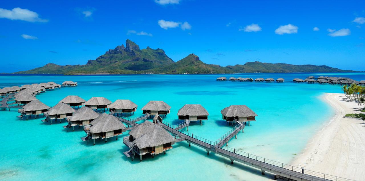 Four Seasons Resort Bora Bora overwater bungalows on Motu Tehotu with the iconic Mount Otemanu rising in the background — the most photographed luxury resort view in French Polynesia