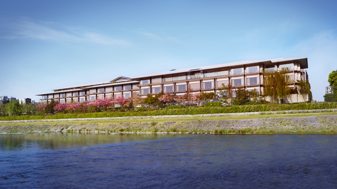 The Ritz-Carlton, Kyoto on the banks of the Kamogawa River with the substantial contemporary Heian-inspired interior identity and the dedicated river-and-Higashiyama orientation evocative of the property's specific central Kyoto luxury configuration