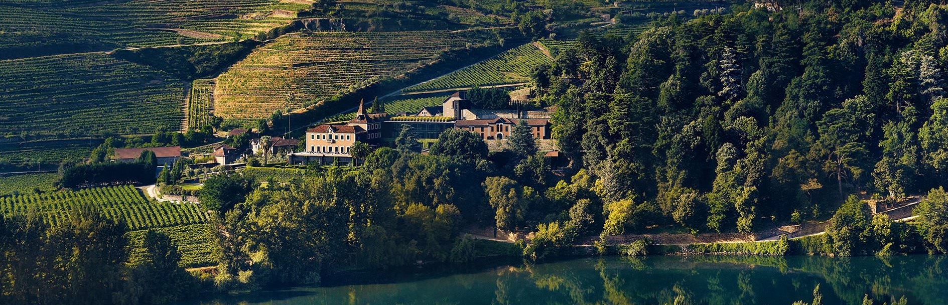 Six Senses Douro Valley — the substantial 19th-century quinta-and-vineyard property occupying a dramatic Douro River escarpment in the heart of the UNESCO-listed Douro Valley wine region of Portugal with the dedicated terraced-vineyard orientation and the substantive river-and-valley views