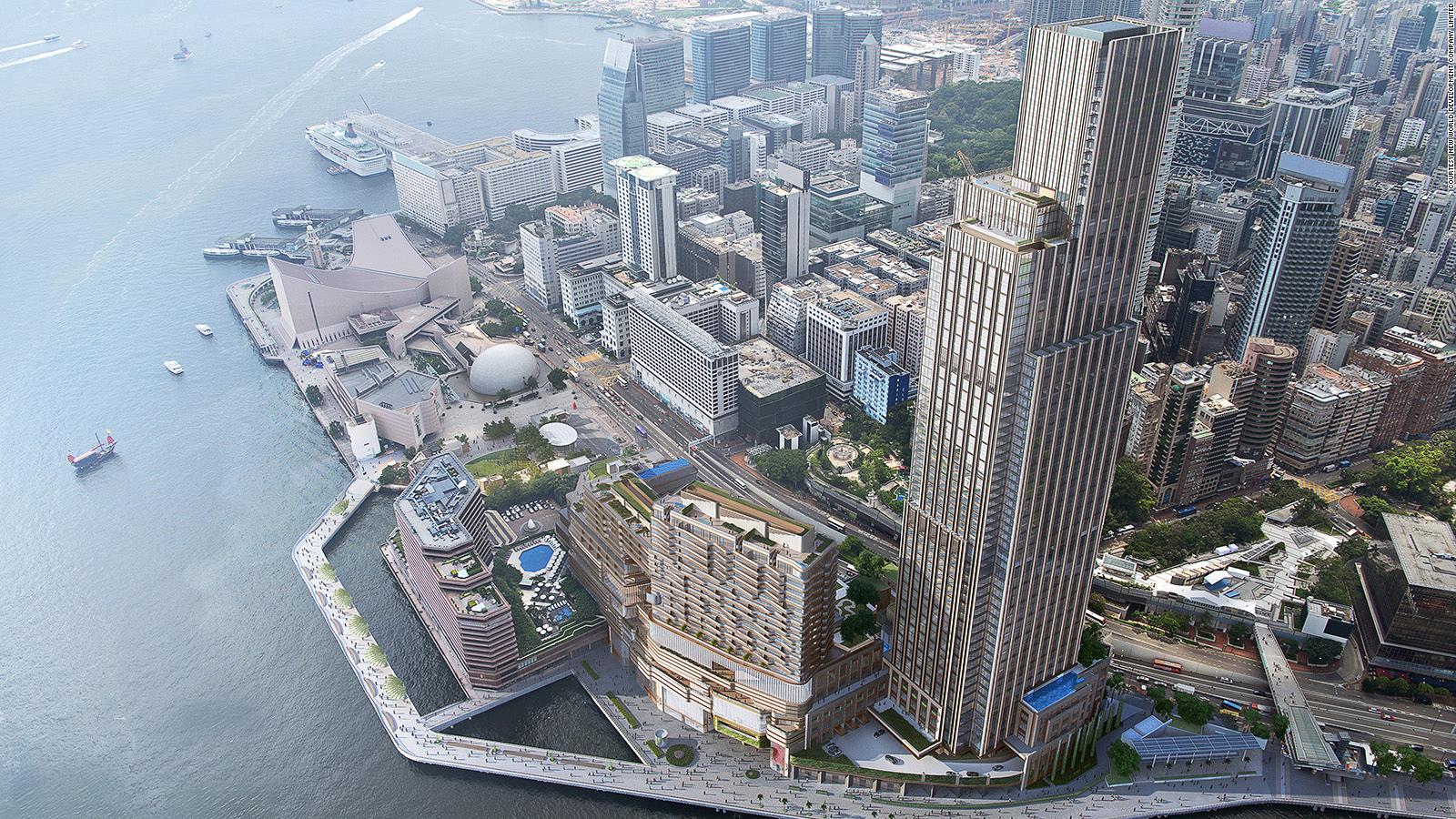 Rosewood Hong Kong at Victoria Dockside in Tsim Sha Tsui with the substantial vertical-estate tower and the unobstructed Victoria Harbour view across to Hong Kong Island — the New World Development flagship