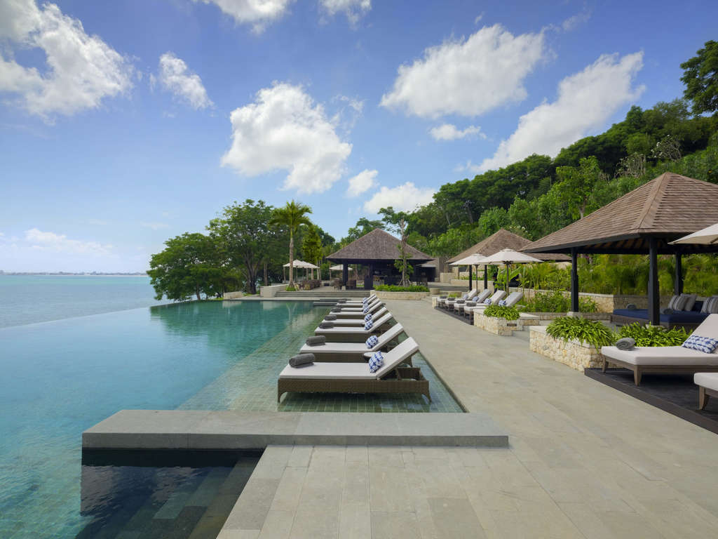 Raffles Bali set on the clifftop above Jimbaran Bay with the dedicated ocean villas cascading down the cliffside and the Indian Ocean orientation that defines the property's substantial position on the Bukit Peninsula