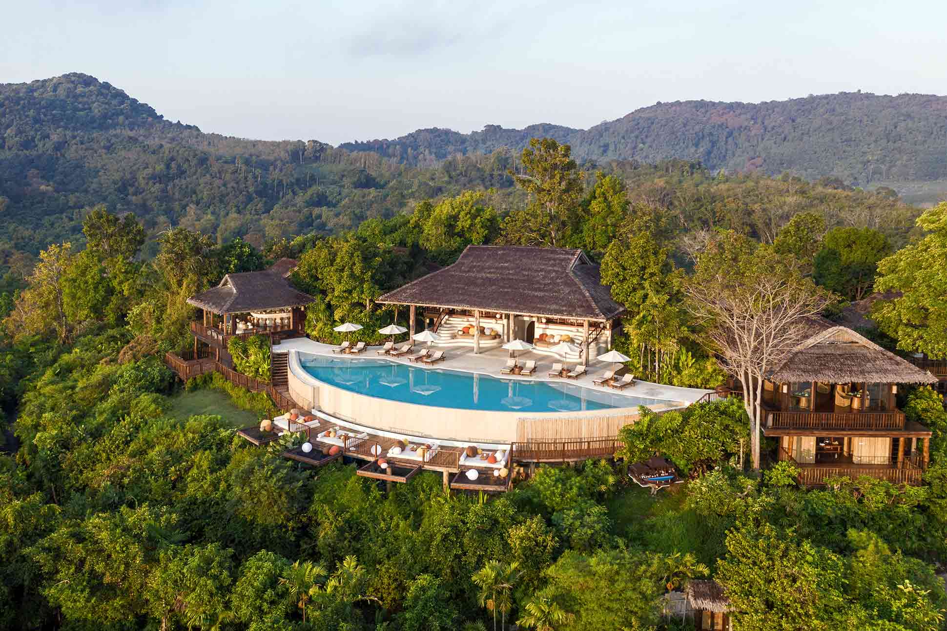 Six Senses Yao Noi on Koh Yao Noi island in Phang Nga Bay with the dramatic limestone karst islands rising from the Andaman Sea — among the most photographically distinctive luxury resort settings in Southeast Asia